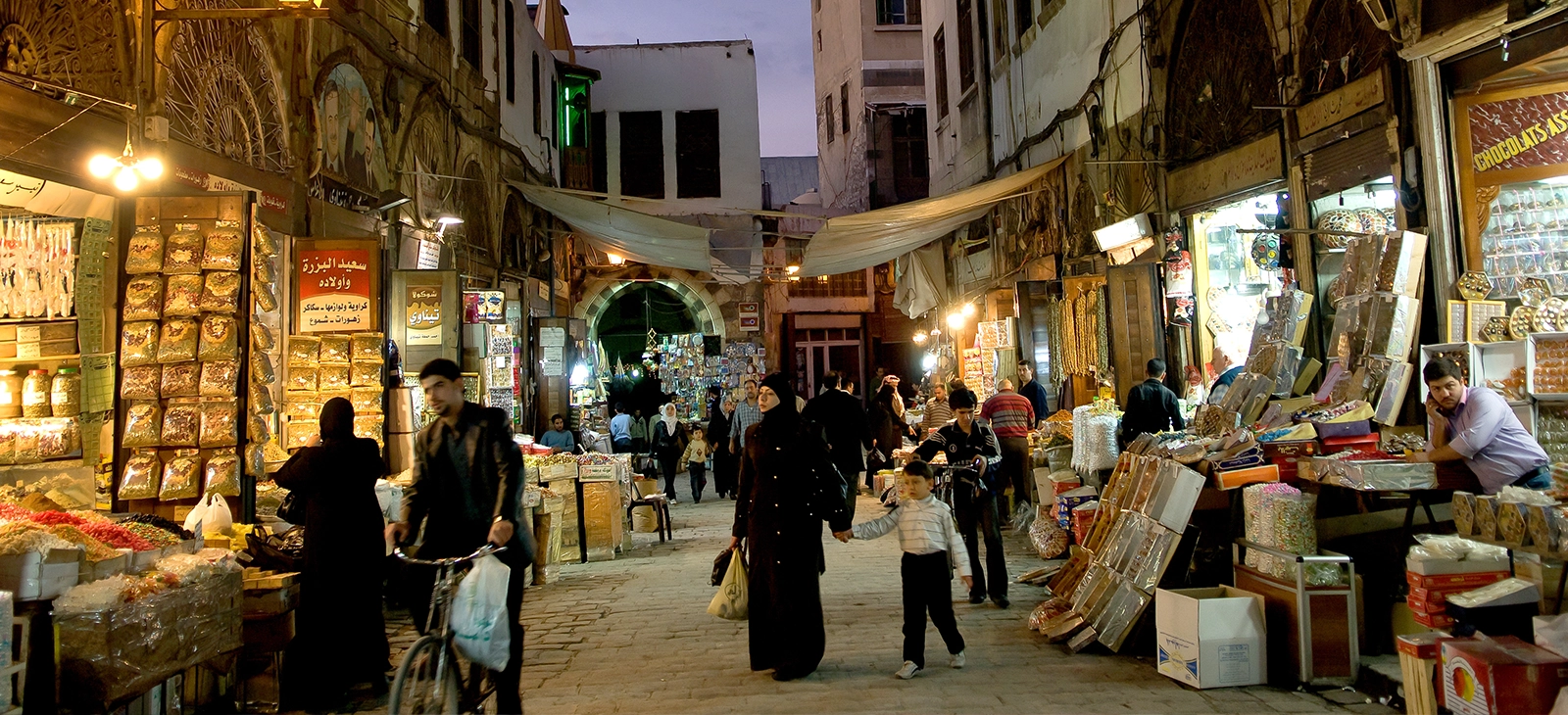 People shopping at a traditional spice market in the Middle East

