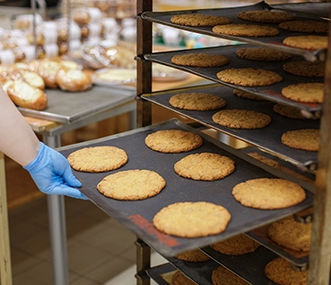 Freshly baked protein cookies on tray in bakery