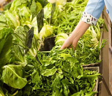 Women choosing vegetables at super market