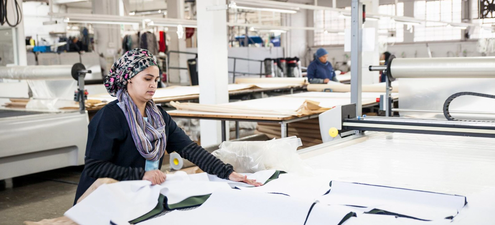 Worker in textile factory for sustainable fashion clothing


