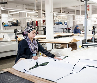 Worker in textile factory for sustainable fashion clothing

