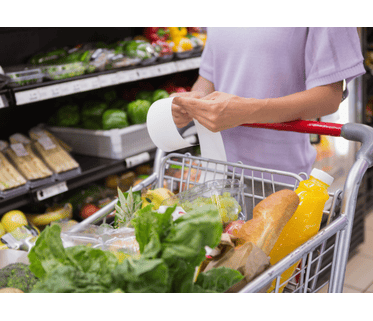 Customer with grocery cart and shopping bill